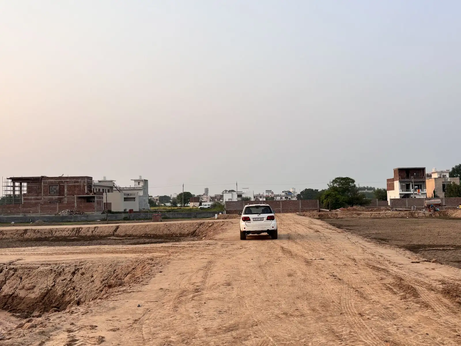 Approach road leading into The Ridge plotted township, Kurali