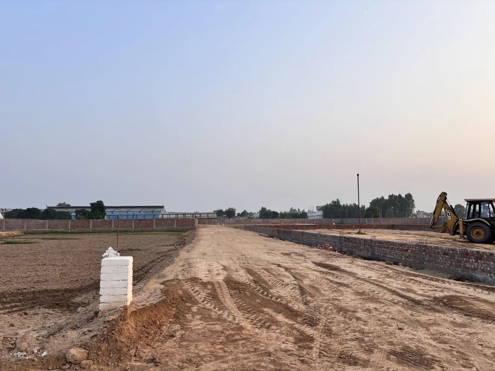 Boundary wall alongside an internal road at The Ridge, Kurali