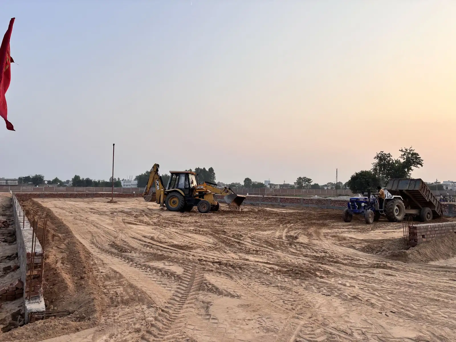 Excavator and tractor working on roads at The Ridge plots project, Kurali