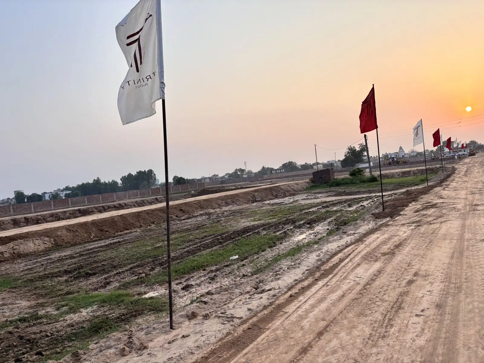 Wide internal road marked out with flags at The Ridge township in Kurali