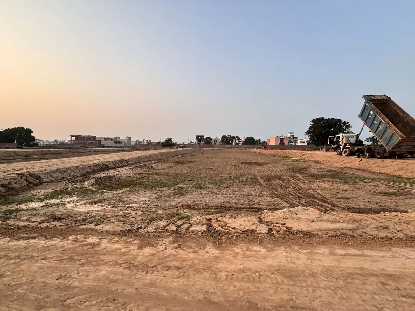 Tipper truck levelling land at The Ridge residential plots project, Kurali