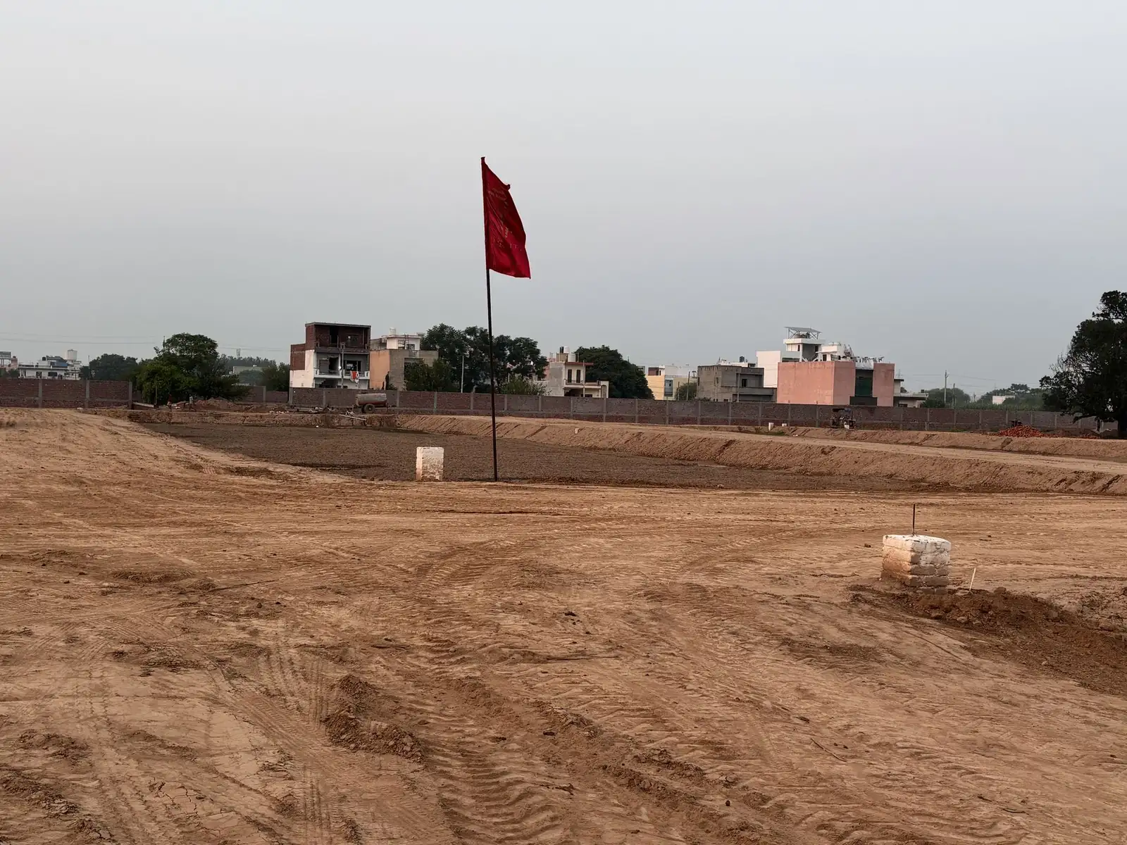 Plot boundary markers beside an internal road at The Ridge, Kurali