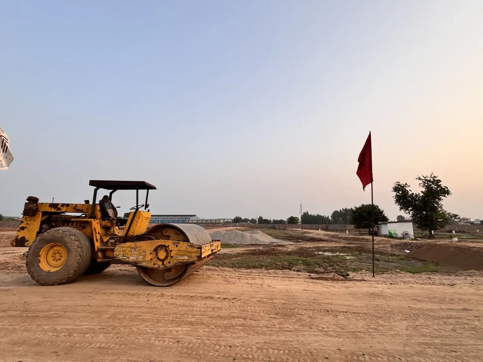 Road roller compacting an internal road at The Ridge residential plots site in Kurali