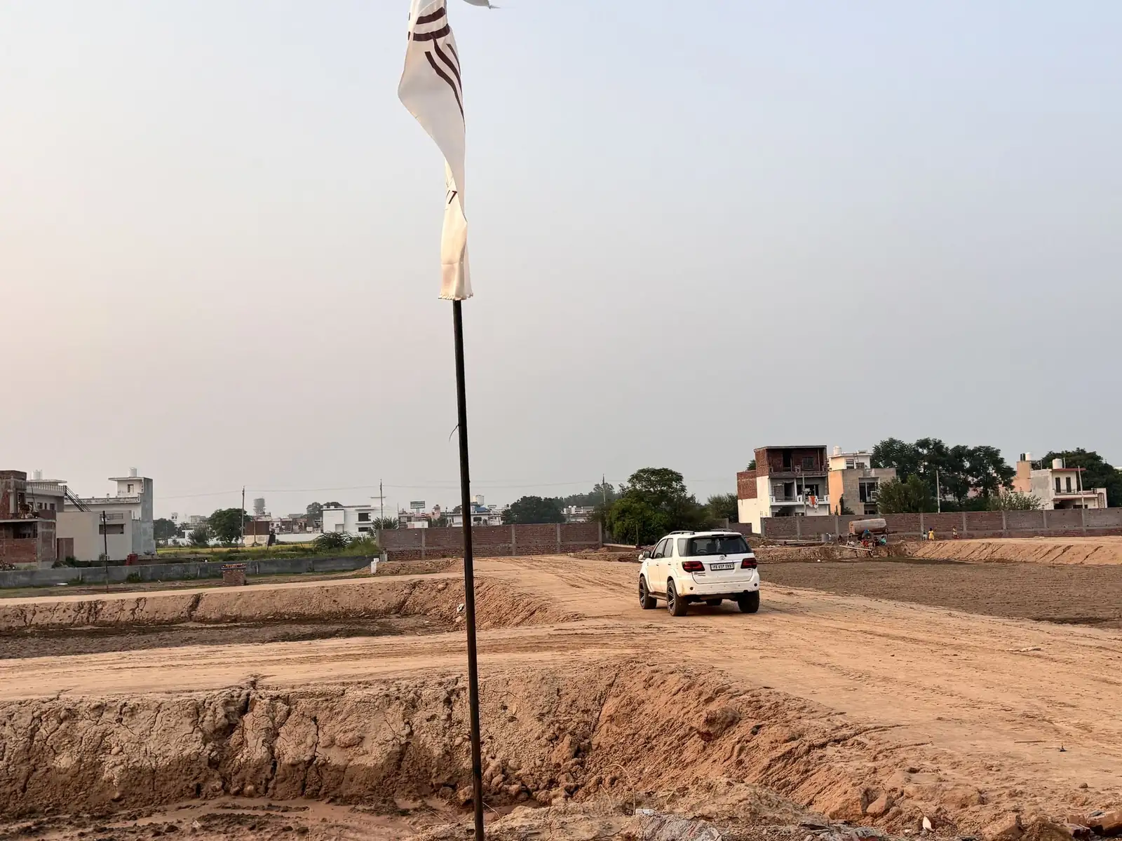 Car on the site entry road at The Ridge, Kurali